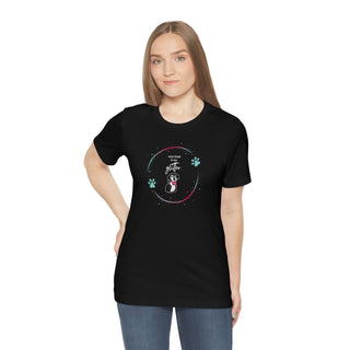 Dog Hair is my Glitter Unisex Jersey Short Sleeve Tee in Black. The Dog Hair is my Glitter design features a dog with the phrase "Dog Hair is my Glitter" above it and it is surrounded by a circle with paw prints.