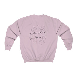 Live in the Moment Crewneck Sweatshirt in Light Pink. The Live in the Moment design features a graphic on the back with the phrase "Live in the Moment" surrounded by shooting stars.