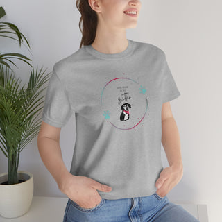 Dog Hair is my Glitter Unisex Jersey Short Sleeve Tee in Athletic Heather. The Dog Hair is my Glitter design features a dog with the phrase "Dog Hair is my Glitter" above it and it is surrounded by a circle with paw prints.