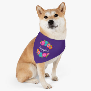 Dog wearing the Dia De Los Muertos Dog Collar Bandana in Purple. The Dia De Los Muertos design features the Benefit Beagle logo with flowers surrounding it. Comes with adjustable black collar.