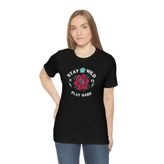 Stay Wild Unisex Premium Tee in Black. Shown is front of Stay Wild Design features a tattoo style rose with the phrase "Stay Wild, Play Hard" around it. The back of shirt features the Stay Wild Benefit Beagle Logo Design.