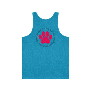 Different Pawspectives Unisex Jersey Tank in Aqua Triblend. Shown is the back of shirt featuring a large colorful pawprint with the the phrase "Life is all about finding the beauty in a different pawspective" circled around it. The Benefit Beagle Logo is located in the top corner on the front of shirt.