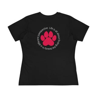 Different Pawspective Women's Premium Tee in Black. Shown is the back of shirt featuring a large colorful pawprint with the the phrase "Life is all about finding the beauty in a different pawspective" circled around it. The Benefit Beagle Logo is located in the top corner on the front of shirt.