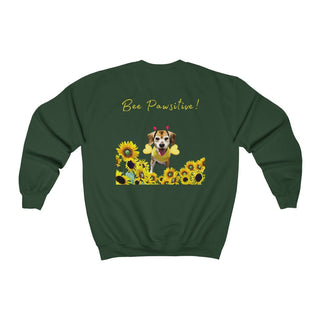 Bee Pawsitive Unisex Crewneck Sweatshirt shirt in Forest Green. Shown is back of shirt showcasing a dog dressed as as bee in a a field of sunflowers with the phrase "Bee Pawsitive!" above it. The front features the Bee Pawsitive Benefit Beagle Logo.