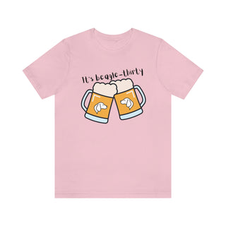 Beagle-Thirty Mugs Unisex Jersey Short Sleeve Tee in Pink. The front of shirt showcases Two Dog Adorned Mugs clinking with the saying, "It's Beagle-Thirty" above it. Back of shirt features corresponding Benefit Beagle Logo.