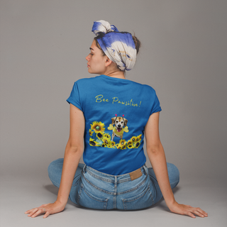 Bee Pawsitive Women's Softstyle Tee in Royal. Shown is back of shirt showcasing a dog dressed as as bee in a a field of sunflowers with the phrase "Bee Pawsitive!" above it. The front features the Bee Pawsitive Benefit Beagle Logo.