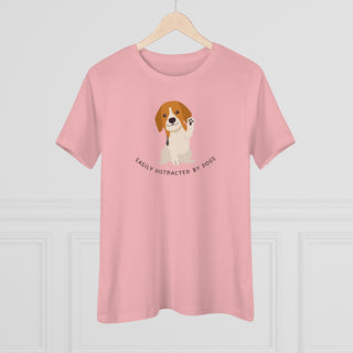 Easily Distracted Women's Premium Tee in Pink. Shown is front design featuring a dog waving with the saying "Easily Distracted by Dogs" below it. The back of shirt has the classic Benefit Beagle Logo.