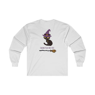 Witchy Cat Unisex Ultra Cotton Long Sleeve Tee. Back side shown in White with Wide Eyed Cartoon Cat wearing Purple Hat Standing over Broom. "Crossing Paths Since 1692". On the front of shirt is similar Witchy Benefit Beagle Logo. Purrfect for Halloween, or anytime!