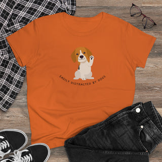 Easily Distracted Women's Midweight Cotton Tee in Orange. Shown is front design featuring a dog waving with the saying "Easily Distracted by Dogs" below it. The back of shirt has the classic Benefit Beagle Logo.