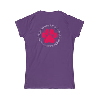 Different Pawspective Women's Softstyle Tee in Purple. Shown is the back of shirt featuring a large colorful pawprint with the the phrase "Life is all about finding the beauty in a different pawspective" circled around it. The Benefit Beagle Logo is located in the top corner on the front of shirt.