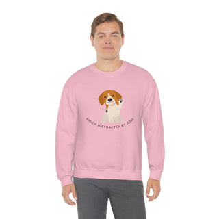 Easily Distracted Unisex Heavy Blend Crewneck Sweatshirt in Pink. Shown is front design featuring a dog waving with the saying "Easily Distracted by Dogs" below it. The back of shirt has the classic Benefit Beagle Logo.