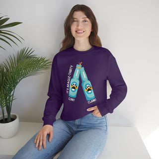 Beagle-Thirty Bottles Unisex Heavy Blend Crewneck Sweatshirt in Purple. The front of shirt showcases Two Paw Labeled Bottles clinking with the saying, "It's Beagle-Thirty". Back of shirt features corresponding Benefit Beagle Logo.