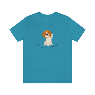 Easily Distracted Unisex Jersey Short Sleeve Tee in Aqua. Shown is front design featuring a dog waving with the saying "Easily Distracted by Dogs" below it. The back of shirt has the classic Benefit Beagle Logo.