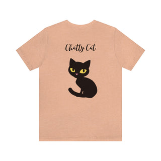 Meow Unisex Tee Heather Peach. Shown is back showcasing a wide eyed black cartoon cat with the phrase "Chatty Cat" above it. On front of shirt is the Benefit Beagle Logo featuring a peeping cat.