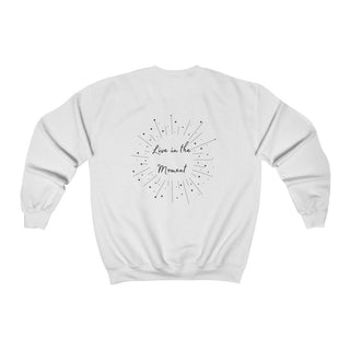 Live in the Moment Crewneck Sweatshirt in White. The Live in the Moment design features a graphic on the back with the phrase "Live in the Moment" surrounded by shooting stars.