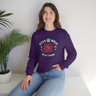 Stay Wild Unisex Heavy Blend Crewneck Sweatshirt in Purple.  The Stay Wild Design features a tattoo style rose with the phrase "Stay Wild, Play Hard" around it. The back of shirt features the Stay Wild Benefit Beagle Logo Design.