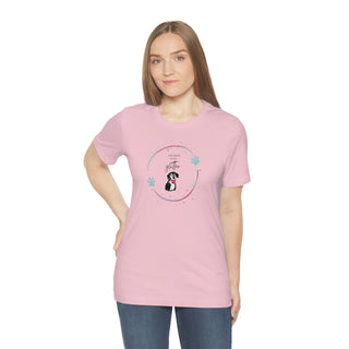 Dog Hair is my Glitter Unisex Jersey Short Sleeve Tee in pink. The Dog Hair is my Glitter design features a dog with the phrase "Dog Hair is my Glitter" above it and it is surrounded by a circle with paw prints.