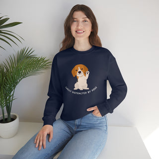 Easily Distracted Unisex Heavy Blend Crewneck Sweatshirt in Navy. Shown is front design featuring a dog waving with the saying "Easily Distracted by Dogs" below it. The back of shirt has the classic Benefit Beagle Logo.