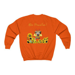 Bee Pawsitive Unisex Crewneck Sweatshirt shirt in Orange. Shown is back of shirt showcasing a dog dressed as as bee in a a field of sunflowers with the phrase "Bee Pawsitive!" above it. The front features the Bee Pawsitive Benefit Beagle Logo.