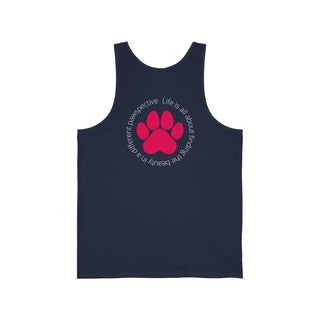 Different Pawspectives Unisex Jersey Tank in Navy. Shown is the back of shirt featuring a large colorful pawprint with the the phrase "Life is all about finding the beauty in a different pawspective" circled around it. The Benefit Beagle Logo is located in the top corner on the front of shirt.