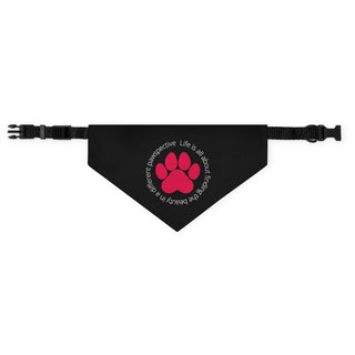  Different Pawspective Dog Collar Bandana in Black. The Different Pawspective design features the phrase "Life is all about finding the beauty in a different pawspective" around a paw print. Comes with adjustable black collar.