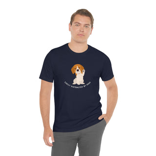 Easily Distracted Unisex Jersey Short Sleeve Tee in Navy. Shown is front design featuring a dog waving with the saying "Easily Distracted by Dogs" below it. The back of shirt has the classic Benefit Beagle Logo.