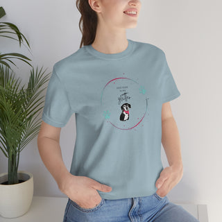 Dog Hair is my Glitter Unisex Jersey Short Sleeve Tee in Light Blue. The Dog Hair is my Glitter design features a dog with the phrase "Dog Hair is my Glitter" above it and it is surrounded by a circle with paw prints.