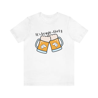 Beagle-Thirty Mugs Unisex Jersey Short Sleeve Tee in White. The front of shirt showcases Two Dog Adorned Mugs clinking with the saying, "It's Beagle-Thirty" above it. Back of shirt features corresponding Benefit Beagle Logo.