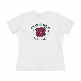 Stay Wild Women's Premium Tee in White. Shown is front of Stay Wild Design features a tattoo style rose with the phrase "Stay Wild, Play Hard" around it. The back of shirt features the Stay Wild Benefit Beagle Logo Design.