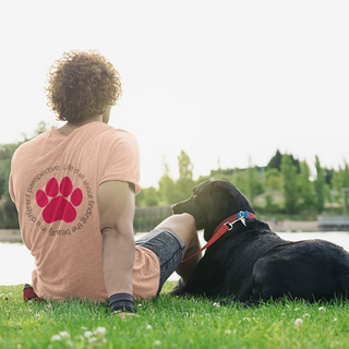 Different Pawspectives Unisex Jersey Short Sleeve Tee in Heather Peach. Shown is the back of shirt featuring a large colorful pawprint with the the phrase "Life is all about finding the beauty in a different pawspective" circled around it. The Benefit Beagle Logo is located in the top corner on the front of shirt.