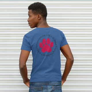 Different Pawspective Unisex V-Neck Tee in Heather True Blue. Shown is the back of shirt featuring a large colorful pawprint with the the phrase "Life is all about finding the beauty in a different pawspective" circled around it. The Benefit Beagle Logo is located in the top corner on the front of shirt.