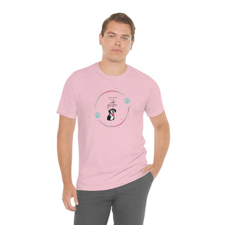 Dog Hair is my Glitter Unisex Jersey Short Sleeve Tee in pink. The Dog Hair is my Glitter design features a dog with the phrase "Dog Hair is my Glitter" above it and it is surrounded by a circle with paw prints.