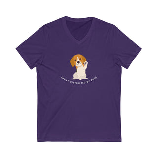 Easily Distracted Unisex Jersey Short Sleeve V-Neck Tee in Team Purple. Shown is front design featuring a dog waving with the saying "Easily Distracted by Dogs" below it. The back of shirt has the classic Benefit Beagle Logo.