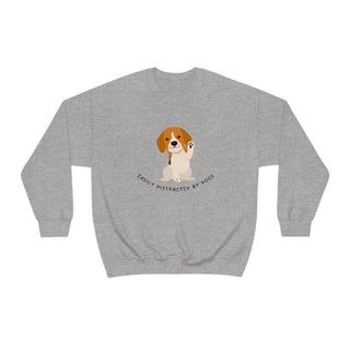 Easily Distracted Unisex Heavy Blend Crewneck Sweatshirt in Sport Grey. Shown is front design featuring a dog waving with the saying "Easily Distracted by Dogs" below it. The back of shirt has the classic Benefit Beagle Logo.