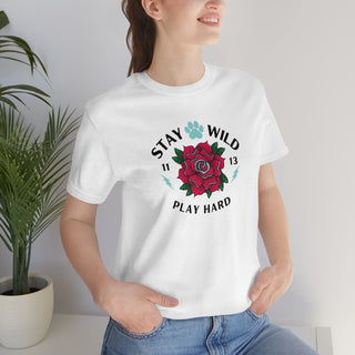 Stay Wild Unisex Premium Tee in White. Shown is front of Stay Wild Design features a tattoo style rose with the phrase "Stay Wild, Play Hard" around it. The back of shirt features the Stay Wild Benefit Beagle Logo Design.