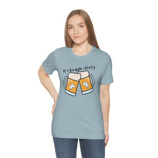 Beagle-Thirty Mugs Unisex Jersey Short Sleeve Tee in Light Blue. The front of shirt showcases Two Dog Adorned Mugs clinking with the saying, "It's Beagle-Thirty" above it. Back of shirt features corresponding Benefit Beagle Logo.