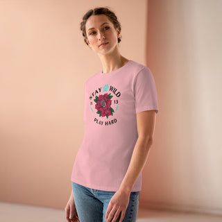 Stay Wild Women's Premium Tee in Pink. Shown is front of Stay Wild Design features a tattoo style rose with the phrase "Stay Wild, Play Hard" around it. The back of shirt features the Stay Wild Benefit Beagle Logo Design.