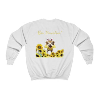 Bee Pawsitive Unisex Crewneck Sweatshirt shirt in White. Shown is back of shirt showcasing a dog dressed as as bee in a a field of sunflowers with the phrase "Bee Pawsitive!" above it. The front features the Bee Pawsitive Benefit Beagle Logo.