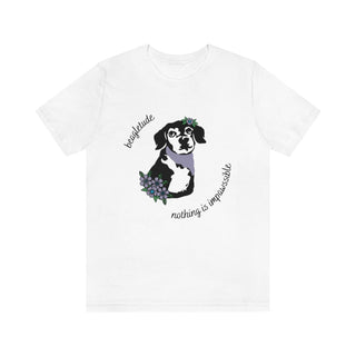 Signature Tattoo Flowers Unisex Jersey Short Sleeve Tee in White. Shown is front of shirt with the Signature Tattoo Flowers design featuring a dog with flowers around it and the phrase "Beagletude" and "Nothing is Impawssible". Back of shirt features the Benefit Beagle Logo