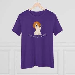 Easily Distracted Women's Premium Tee in Team Purple. Shown is front design featuring a dog waving with the saying "Easily Distracted by Dogs" below it. The back of shirt has the classic Benefit Beagle Logo.