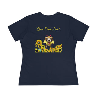 Bee Pawsitive Women's Premium Tee in Navy. Shown is back of shirt showcasing a dog dressed as as bee in a a field of sunflowers with the phrase "Bee Pawsitive!" above it. The front features the Bee Pawsitive Benefit Beagle Logo.