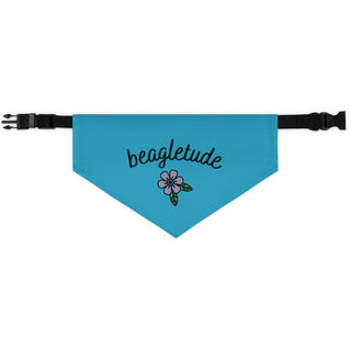 The Signature Tattoo Flower Dog Collar Bandana in Blue. The Signature Tattoo Flower design features the word "beagletude" with a tattoo style flower under it. Comes with adjustable black collar.