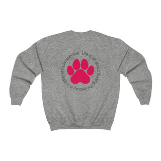 Different Pawspective Unisex Crewneck Sweatshirt in Sport Grey. Shown is the back of shirt featuring a large colorful pawprint with the the phrase "Life is all about finding the beauty in a different pawspective" circled around it. The Benefit Beagle Logo is located in the top corner on the front of shirt.