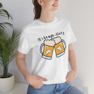 Beagle-Thirty Mugs Unisex Jersey Short Sleeve Tee in White. The front of shirt showcases Two Dog Adorned Mugs clinking with the saying, "It's Beagle-Thirty" above it. Back of shirt features corresponding Benefit Beagle Logo.