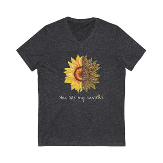 You are my Sunshine Unisex V-Neck Tee in Dark Grey Heather. Shown is the front showcasing a sunflower which is split down the middle and half is made out of paw prints. Underneath is the phrase "You are my Sunshine" . Back of shirt features the Sunflower Benefit Beagle Logo.