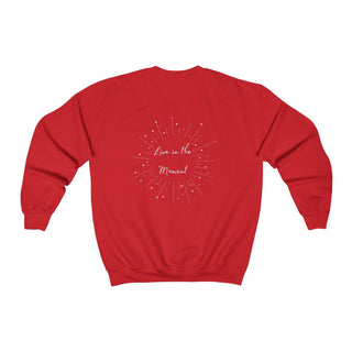 Live in the Moment Crewneck Sweatshirt in Red. The Live in the Moment design features a graphic on the back with the phrase "Live in the Moment" surrounded by shooting stars.