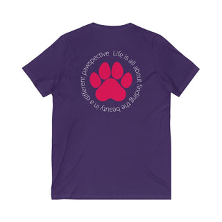 Different Pawspective Unisex V-Neck Tee in Team Purple. Shown is the back of shirt featuring a large colorful pawprint with the the phrase "Life is all about finding the beauty in a different pawspective" circled around it. The Benefit Beagle Logo is located in the top corner on the front of shirt.