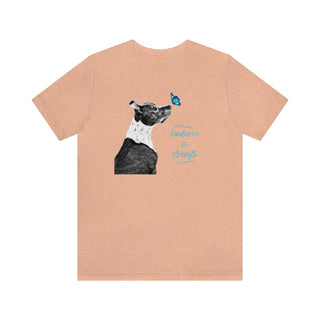 Lincoln Butterfly Unisex Jersey Short Sleeve Tee in Peach. Shown is back of shirt design showcasing profile of a dog with a blue butterfly on its nose and the phrase "Kindness is Strength" next to it. The front of shirt has Benefit Beagle Logo kissed by a Butterfly.