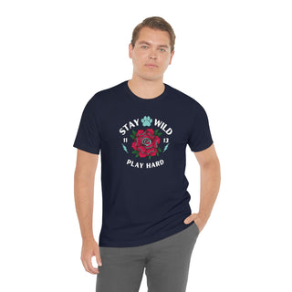 Stay Wild Unisex Premium Tee in Navy. Shown is front of Stay Wild Design features a tattoo style rose with the phrase "Stay Wild, Play Hard" around it. The back of shirt features the Stay Wild Benefit Beagle Logo Design.