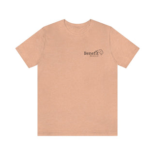 Live in the Moment Unisex Short Sleeve Tee in Heather Peach. The Live in the Moment design features the Benefit Beagle logo in the top corner of the garment.